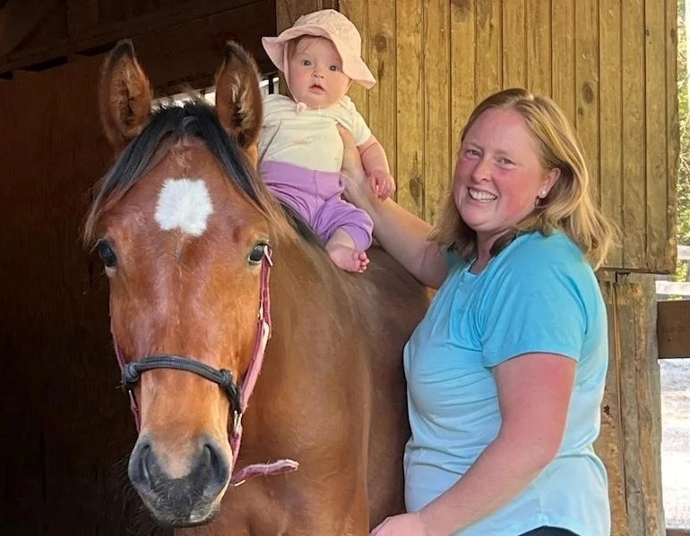 young girl walking horse